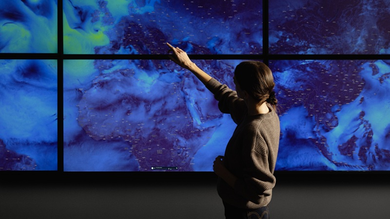 Person pointing at a demo screen