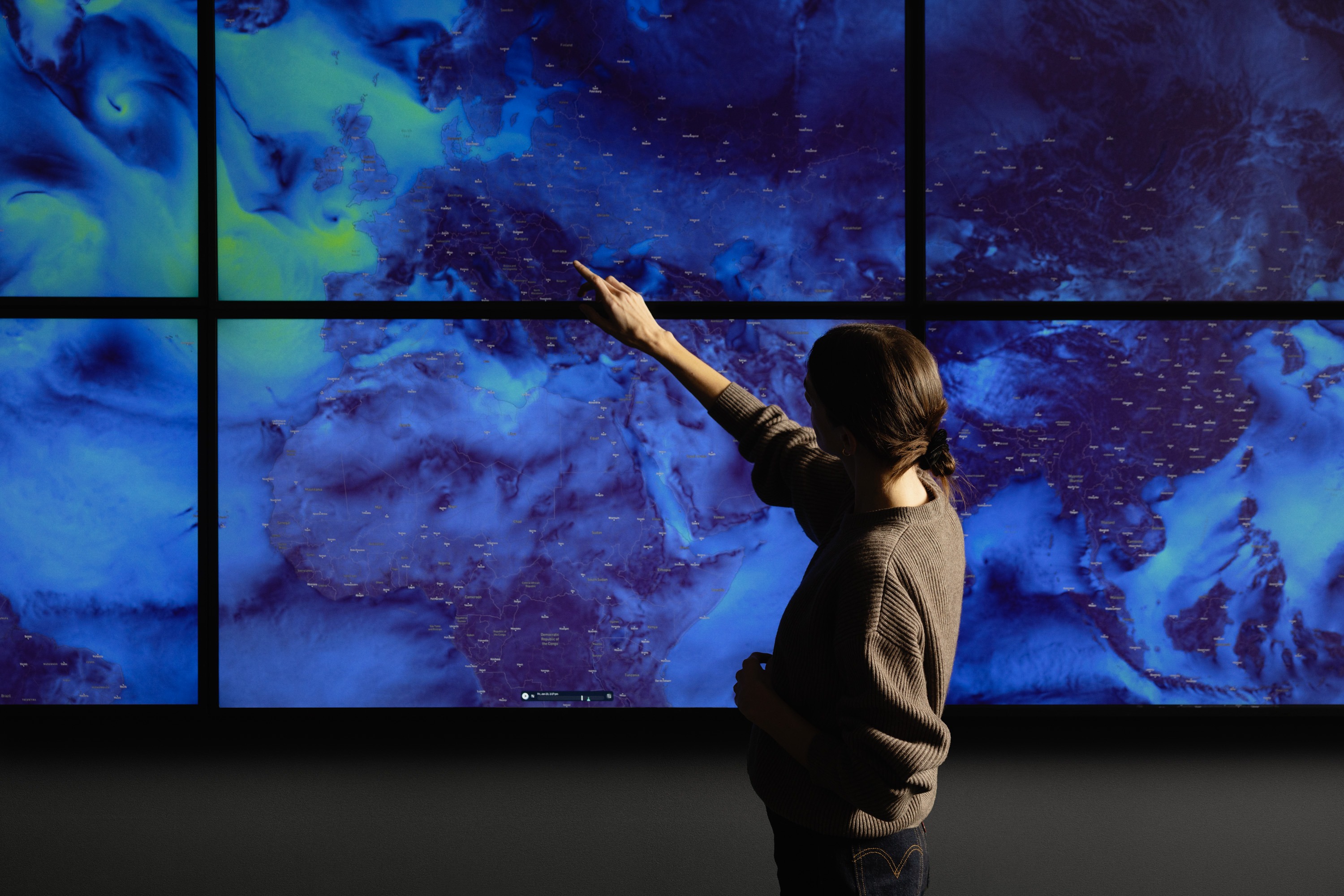 Person pointing at a screen