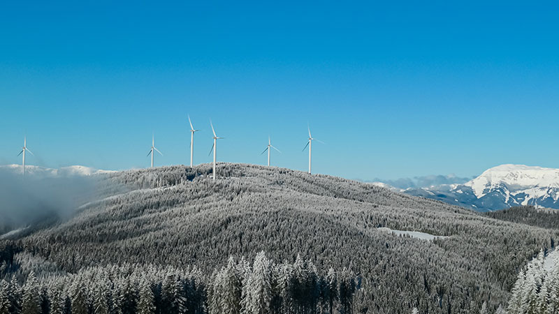 Wind turbines on snow covered ridge