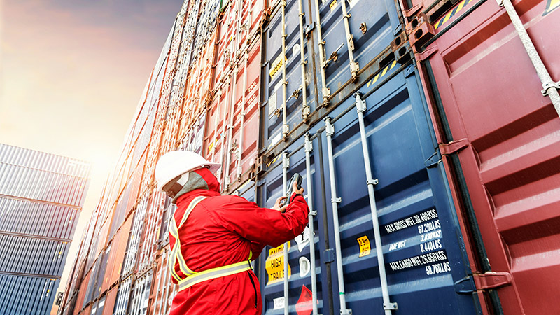 Foreman in front of containers