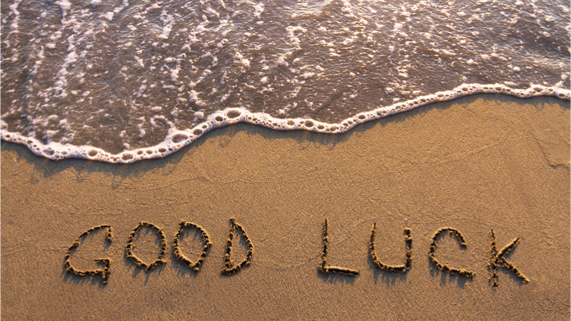 Good luck written to sand