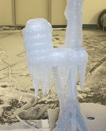 An outdoor sensor completely covered in ice after a freezing rain test