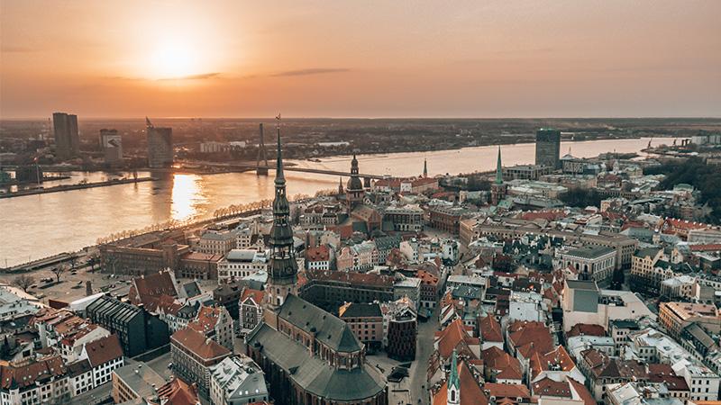 RIga rooftop view panorama at sunset with urban architectures and Daugava River. View of the old town