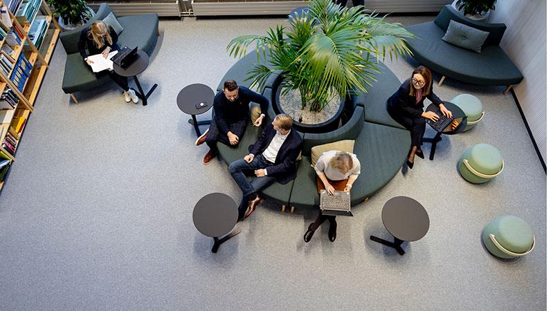 People sitting at a lobby and working.