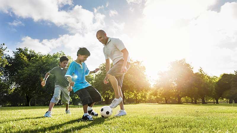 A family playing football outside.