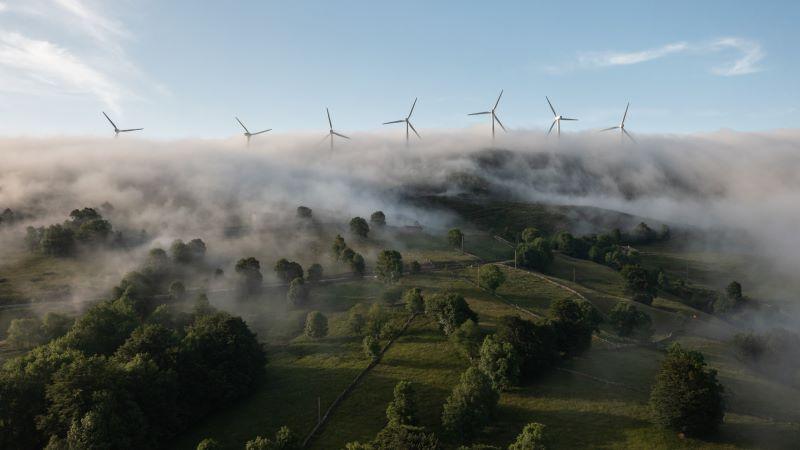 Wind turbines on a foggy field
