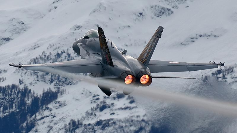 Fighter jet with snowy mountains in background