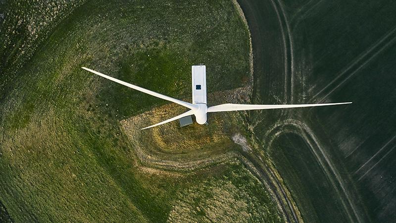 Wind turbine on a field - aerial view