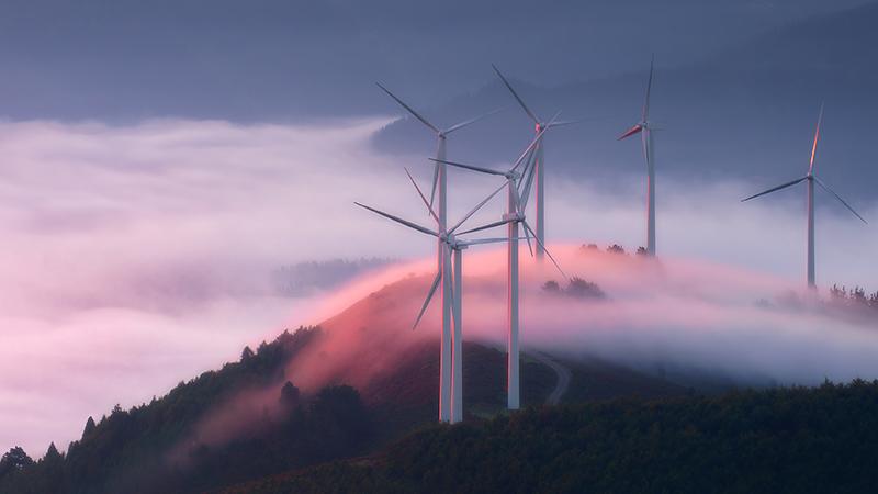 Wind turbines on a misty hill