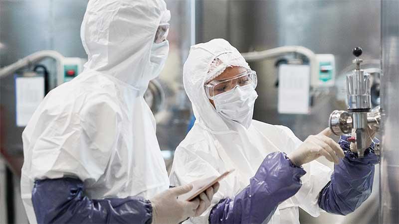 Two workers at a modern chemical plant