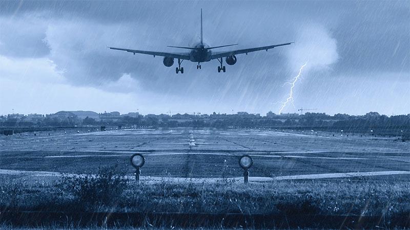 Airplane landing to in a stormy weather to a runway at the airport