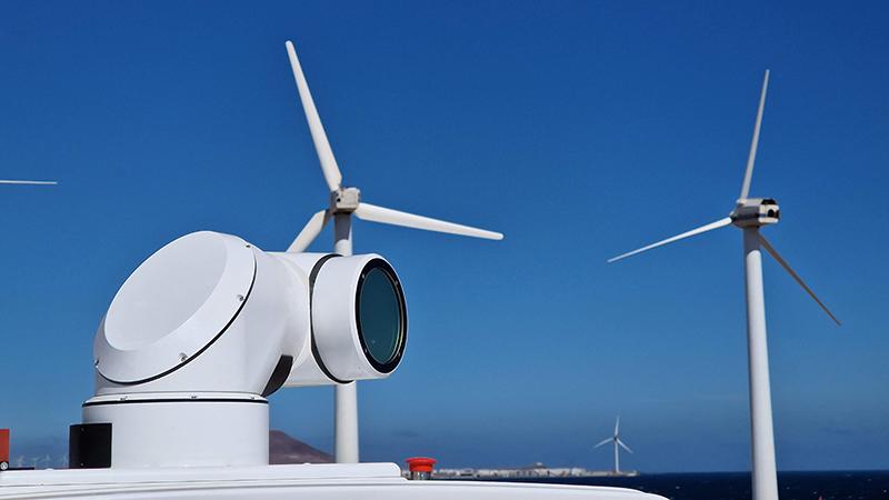 WindCube closeup with wind turbines in the back.