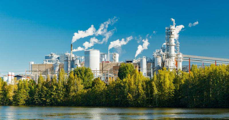 Modern pulp mill in Finland with chimneys and process buildings