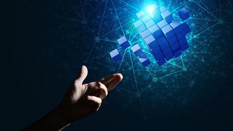 A man's hand reaching for a modular cube