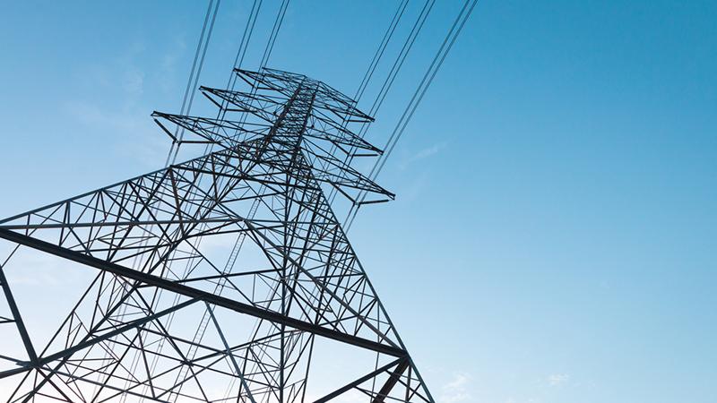 Electricity transmission power lines at sunset (High voltage tower)