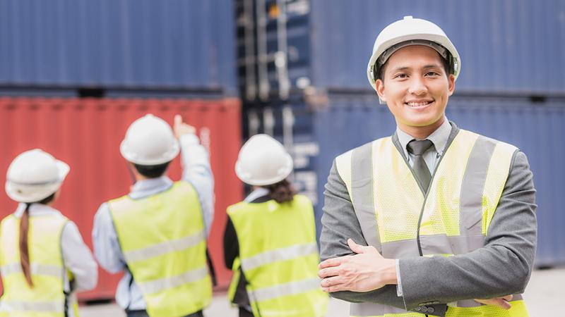 Men in front of shipping containers