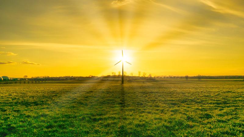 Wind turbine at sunset at a biogas plant