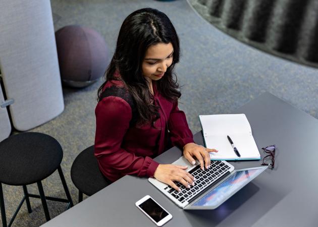 Woman working on a laptop.