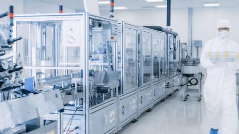 man walking pharmaceutical laboratory cleanroom