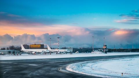 Aircraft at International Airport terminal at sunrise.