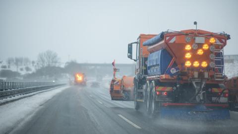 Roadsalt truck on the autobahn during snowfall.