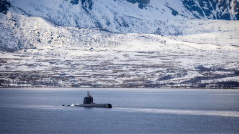 Military submarine by a snowy coast