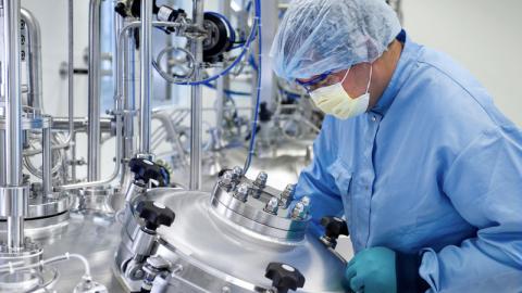 Chemical laboratory technician working in laboratory.