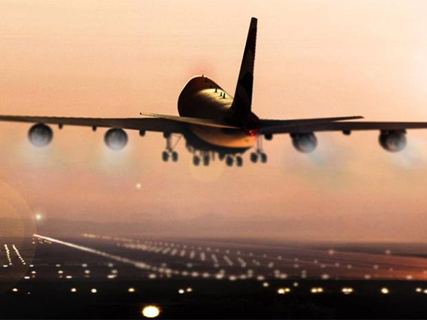 Airplane landing at sunset