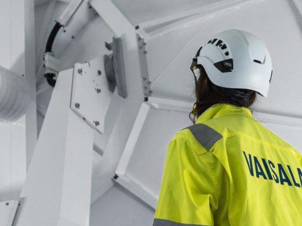 Inside Vaisala weather radar with technician.