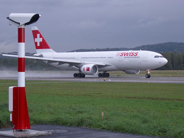 Vaisala AWOS on airport with plane landing.