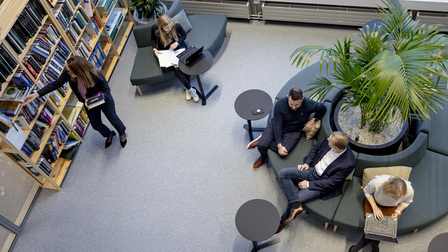 Vaisala employees working and talking in the office