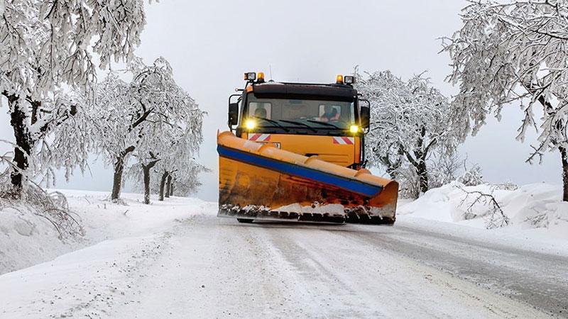 Plow truck in winter road
