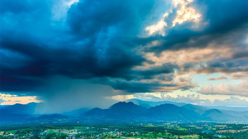 Mountainous landscape with dark clouds above