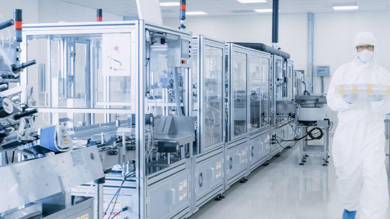man walking pharmaceutical laboratory cleanroom