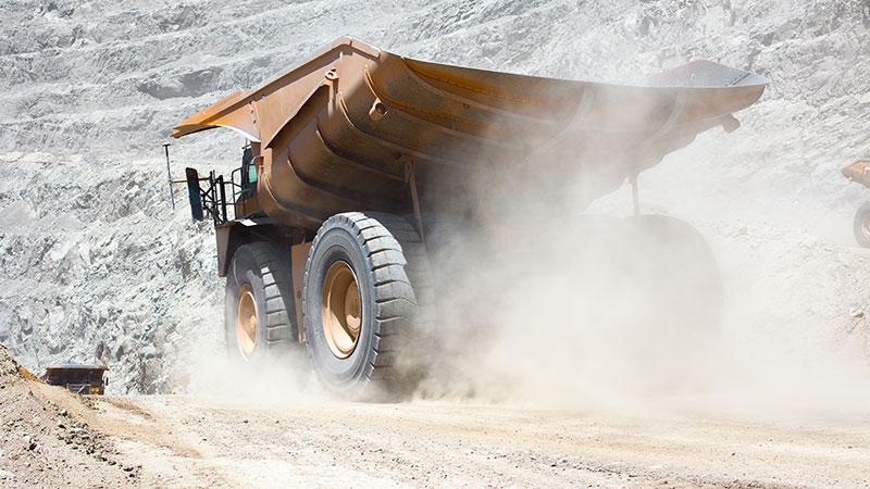 Truck driving through dusty mine