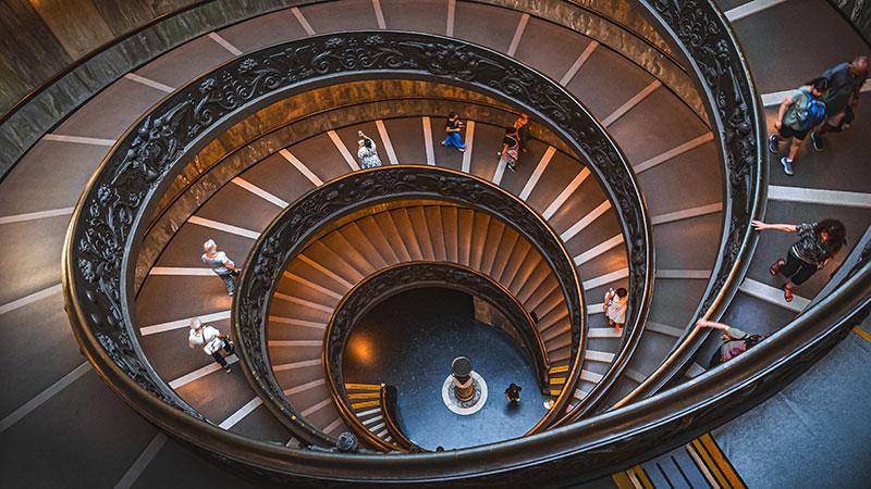 People walking on museum spiral staircase
