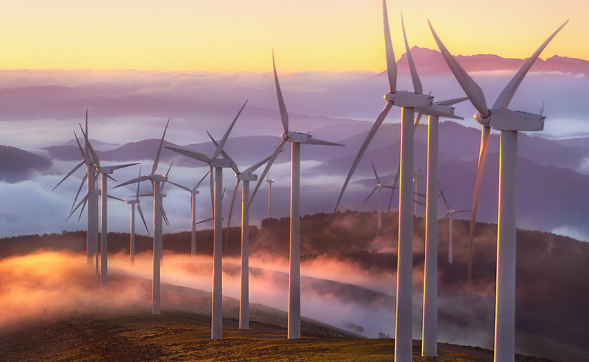 Wind turbines on a hill on a misty morning