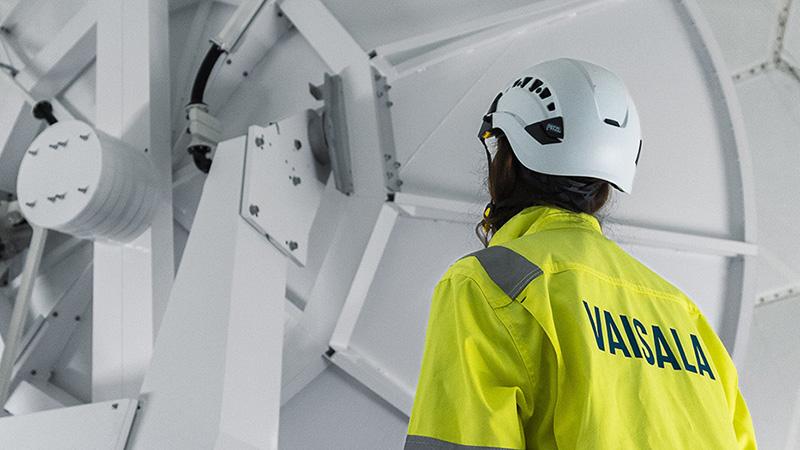Inside Vaisala weather radar with technician.