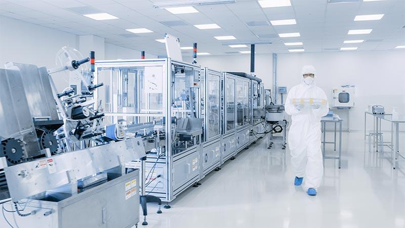 Operator walking in pharmaceutical laboratory cleanroom