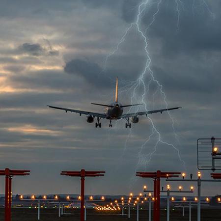 Airplane taking off during a lightning storm.