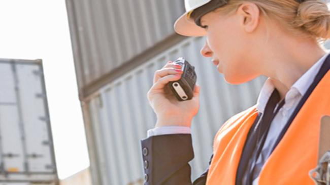 Port worker communicating on a walkie talkie