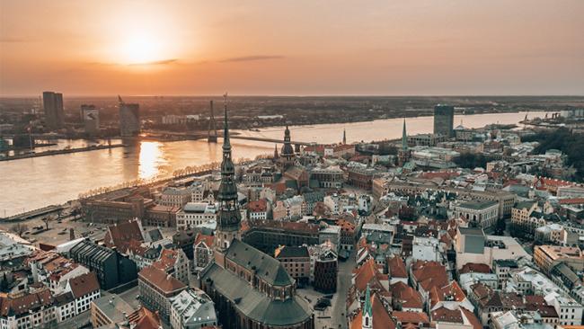 RIga rooftop view panorama at sunset with urban architectures and Daugava River. View of the old town
