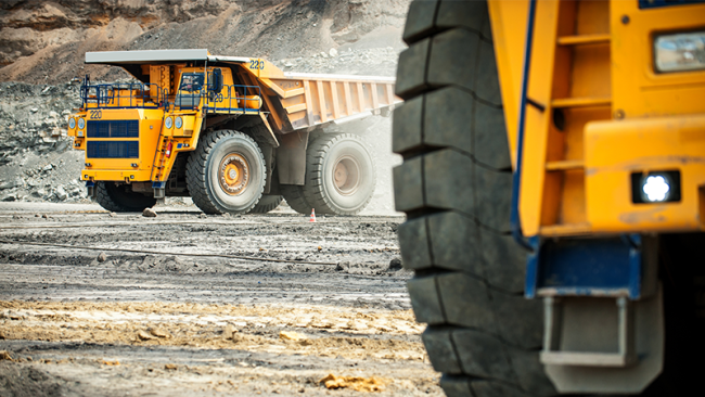 Open pit mine industry, big yellow mining truck for coal anthracite.