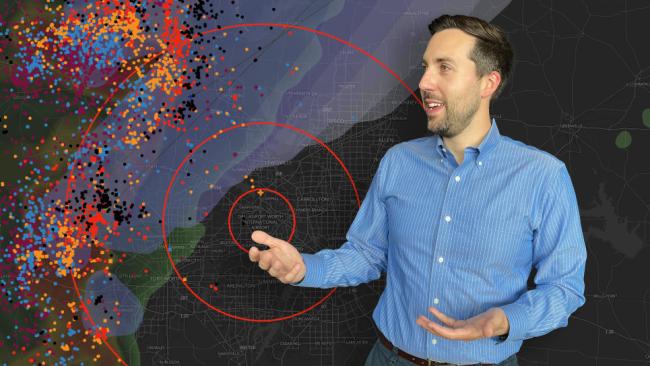 Hans Loewenheath stands in front of a map showing lightning activity around Dallas Fort Worth airport