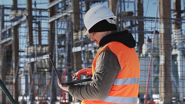 Vaisala technical engineer checking a transformer