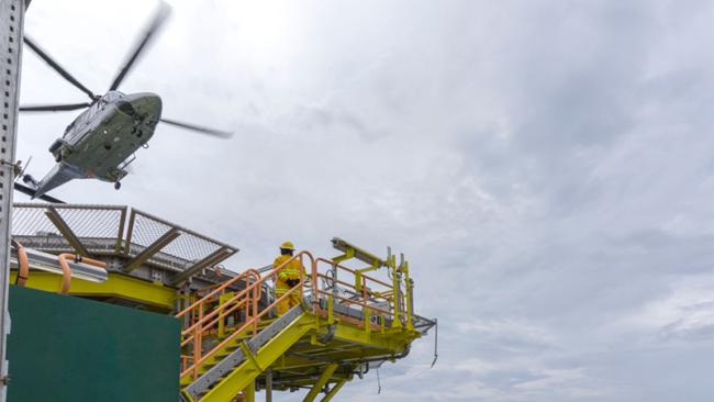 Helicopter landing on oil rig