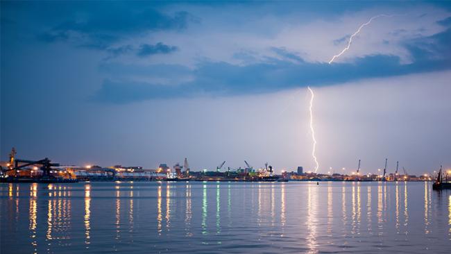 Lightning over ships in a port