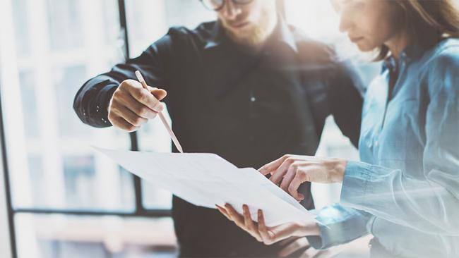 Team looking at sheet in office