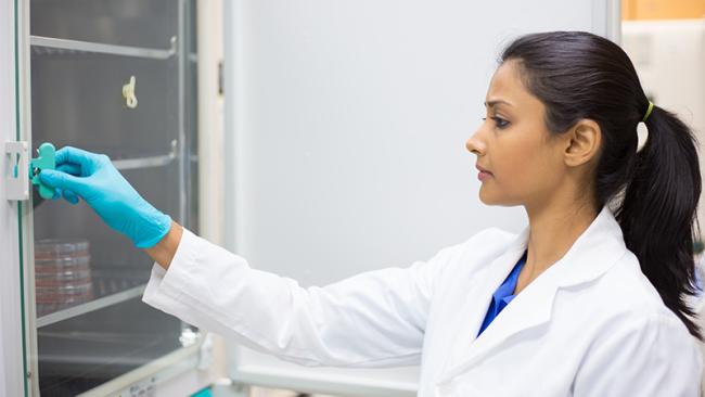 Woman in front of an incubator