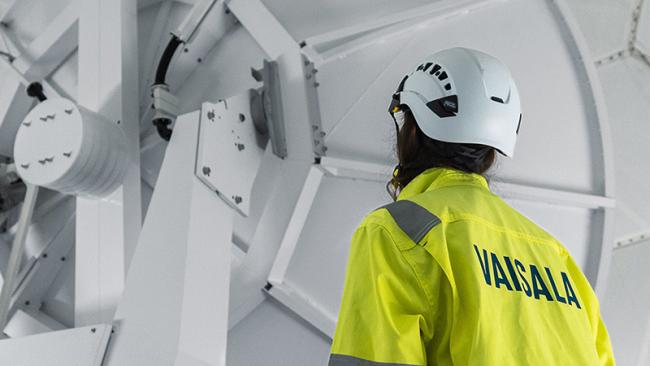 Inside Vaisala weather radar with technician.